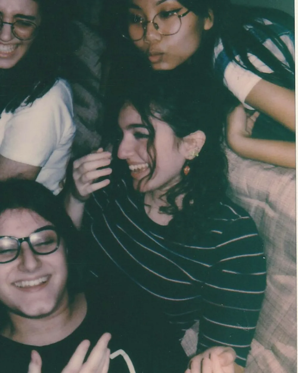 Friends piled together for a flash photo