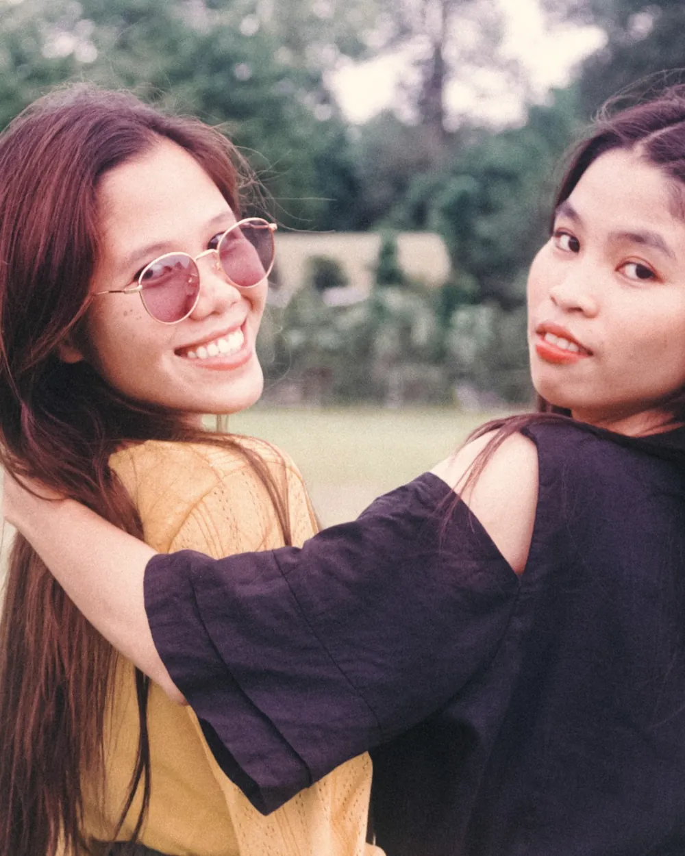 Two friends in sunglasses, grainy film frame